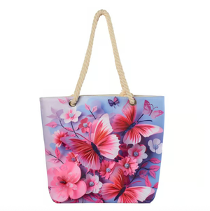 A tote bag featuring pink butterflies and flowers on a blue background, with rope handles.