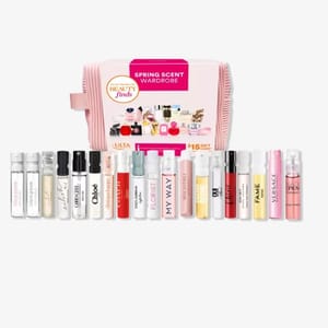 A collection of various branded perfume samples presented in a pink striped box.
