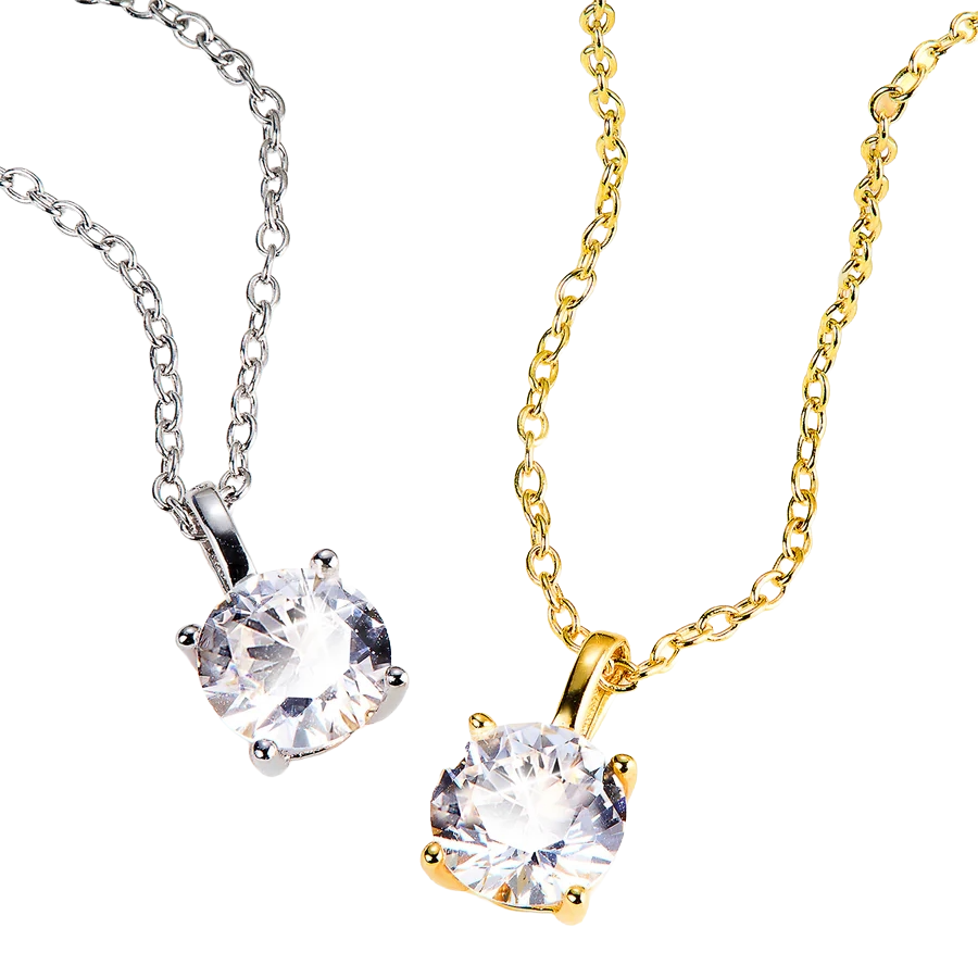 Two necklaces with round clear gemstones: one with a silver chain and setting, the other with a gold chain and setting.