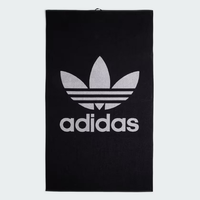 A black towel with a large gray Adidas logo in the center.