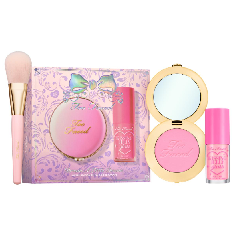 Too Faced makeup set including a pink blush and lip gloss duo with a brush. The packaging is adorned with a bow design.
