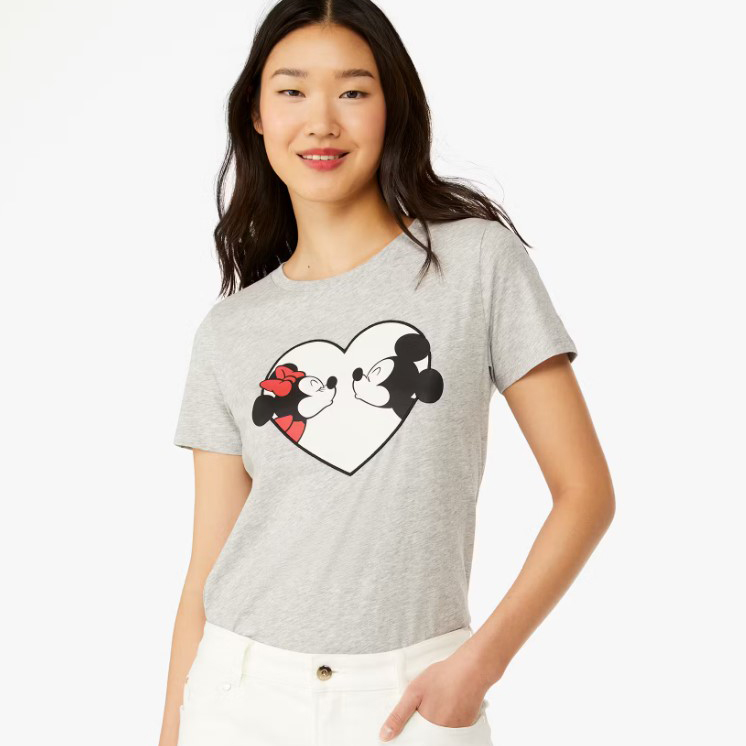 A woman wearing a gray t-shirt with an animated character couple design inside a heart shape.