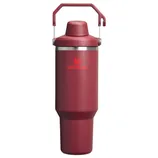 A red Stanley travel mug with a handle, featuring a leak-proof lid.