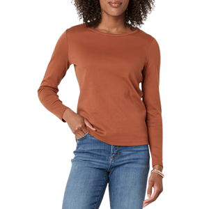 A woman is wearing a long-sleeve brown shirt paired with blue jeans.