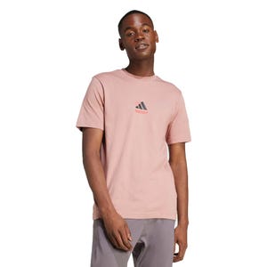Pink Adidas Lounge Graphic Tee with a small Adidas logo on the chest, paired with gray pants. The t-shirt features a casual design suitable for everyday wear.