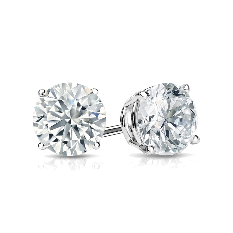 A pair of round, brilliant-cut diamond stud earrings set in a four-prong white metal setting.
