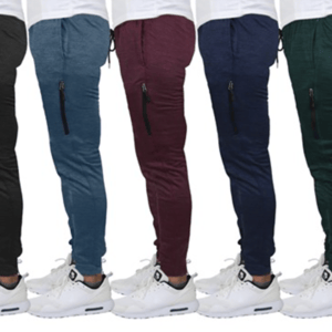 A set of three pairs of men's joggers in gray, blue, and maroon, featuring a drawstring waist, cuffed ankles, and side zippered pockets, paired with white sneakers.