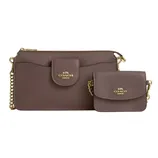 A Coach wristlet and matching mini shoulder bag in brown leather, featuring gold chain straps and gold logo detailing on both items.