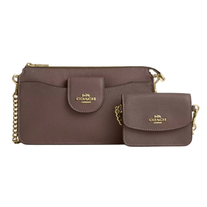 A Coach wristlet and matching mini shoulder bag in brown leather, featuring gold chain straps and gold logo detailing on both items.