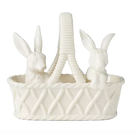 The Lenox Bunny Salt & Pepper Shaker Set features two ceramic bunny figurines sitting in an intricately woven basket with an arched handle. Both bunnies are designed with small holes for dispensing seasoning.