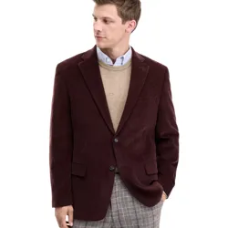 Man wearing a burgundy corduroy blazer, beige sweater, light blue button-up shirt, and plaid trousers, looking to the side.