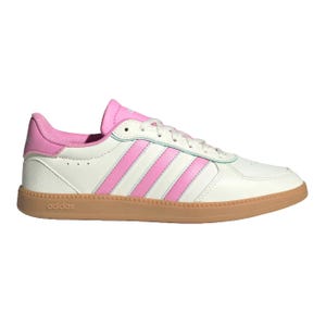 A white and pink Adidas sneaker features the classic three-stripe design. The shoe has a pink tongue, inner lining, and a gum rubber sole.