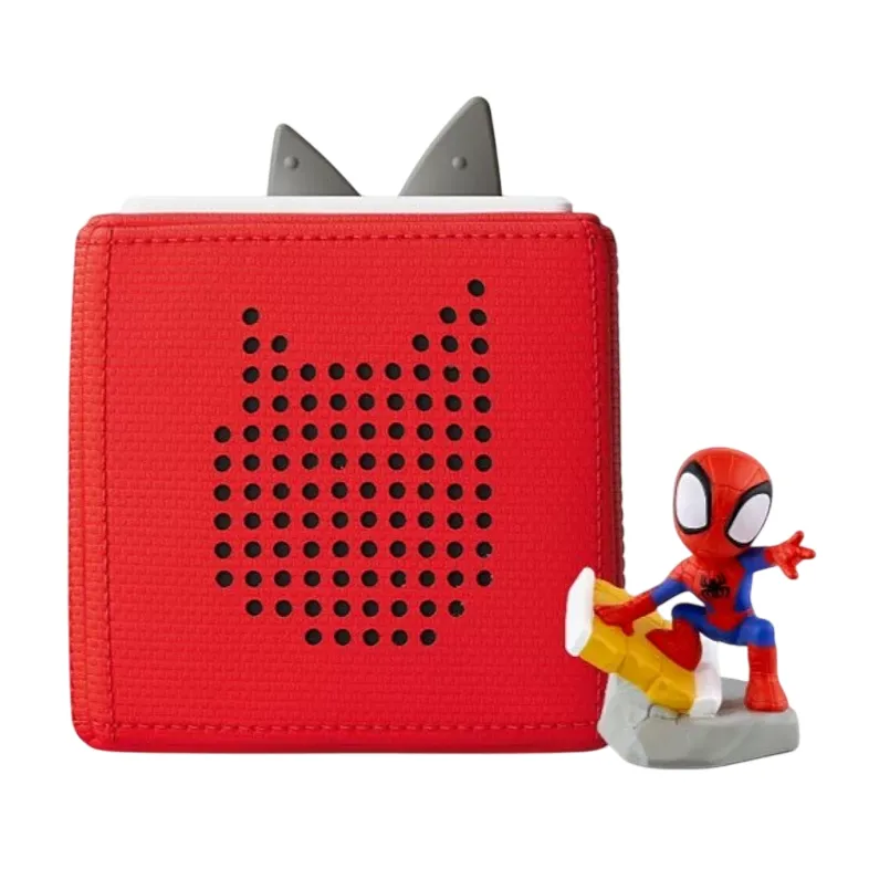 Red audio speaker with perforated design and two gray triangular controls on top, accompanied by a small, action figure resembling a superhero in a red and blue costume.