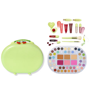 A lime green makeup case with cherry details includes various makeup items: lip glosses, cream tubes, nail polishes, brushes, clips, a heart-shaped container, and a large palette with diverse eyeshadow and face colors.