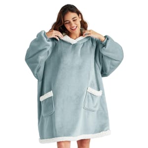 A woman is wearing an oversized, light blue fleece hoodie with fluffy white trim on the sleeves, pockets, and hem, featuring two front pockets and a comfortable fit.