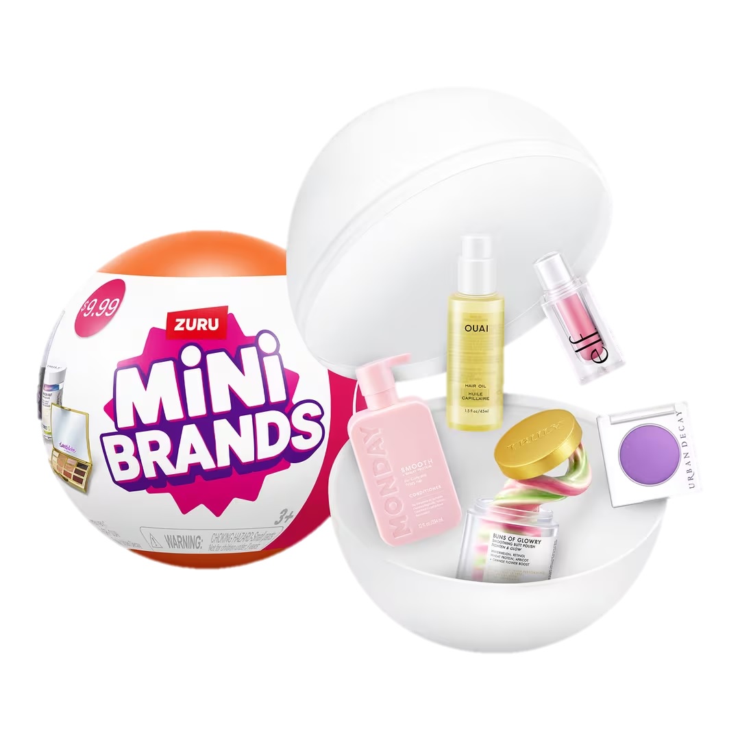 A Zuru Mini Brands capsule opened to reveal miniature beauty products including shampoo, oil, and makeup items.