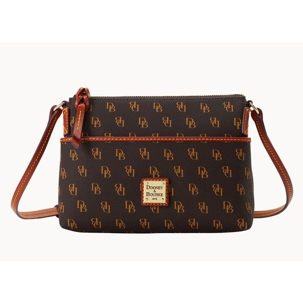A Dooney & Bourke crossbody bag featuring a brown monogram pattern with \“DB\“ initials and tan leather accents, plus a front logo patch.
