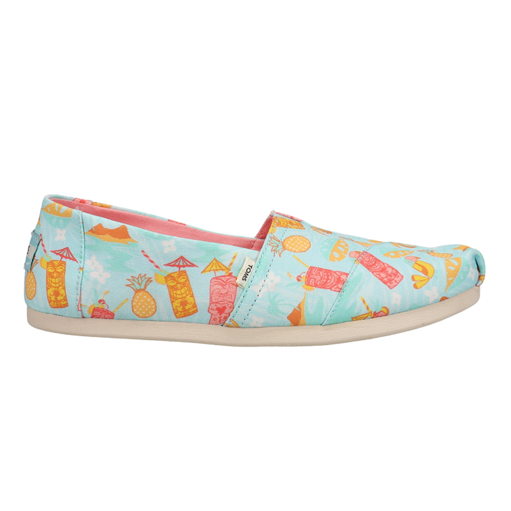 TOMS Tropical-Print Alpargata Shoes feature a light blue canvas with colorful tropical drink and pineapple illustrations, paired with a white rubber sole.