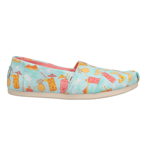 TOMS Tropical-Print Alpargata Shoes feature a light blue canvas with colorful tropical drink and pineapple illustrations, paired with a white rubber sole.
