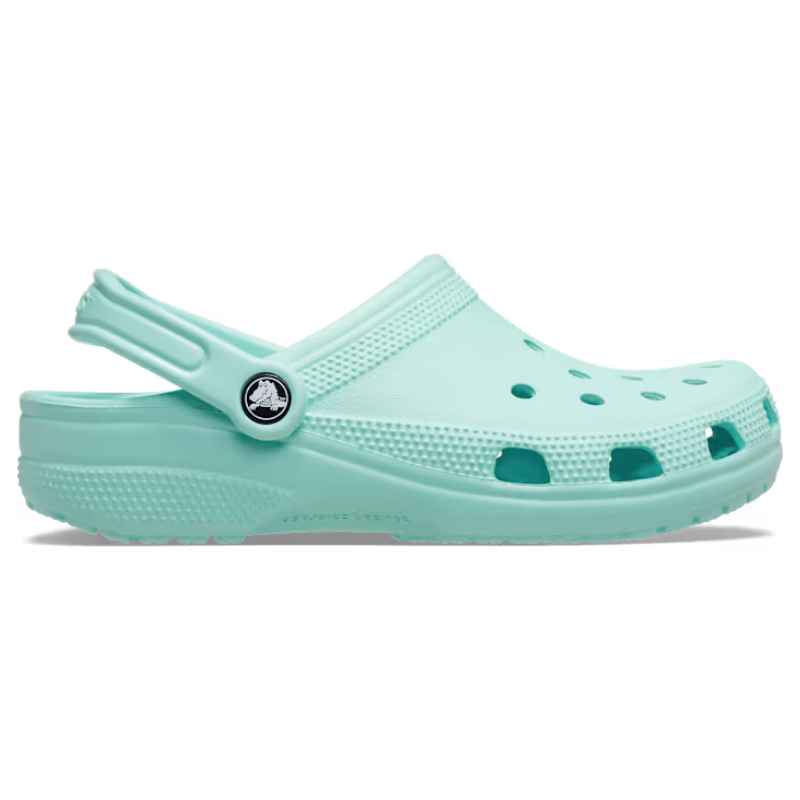A light blue Crocs Classic Clog with ventilation holes, a pivoting heel strap, and cushioned footbed.