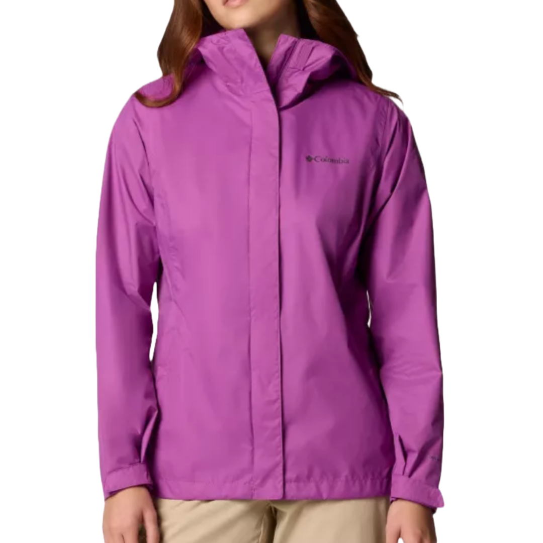A woman is wearing a purple Columbia jacket with a hood, featuring long sleeves and a front zipper. She pairs it with beige pants.