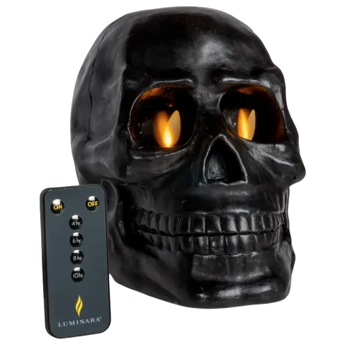 A black skull candle with a flickering flame effect is paired with a remote control featuring on/off and timer buttons.
