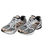 A pair of Saucony running shoes with a gray mesh upper, tan accents, cushioned soles, and white laces.