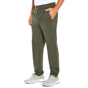A person is wearing olive green jogger pants with side pockets, paired with light gray sneakers and a white shirt.