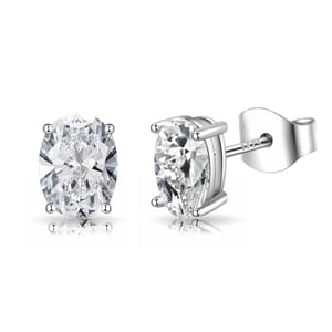 A pair of oval-cut clear gemstone stud earrings set in a four-prong silver setting with butterfly backs, marked \“S925\“ indicating sterling silver.