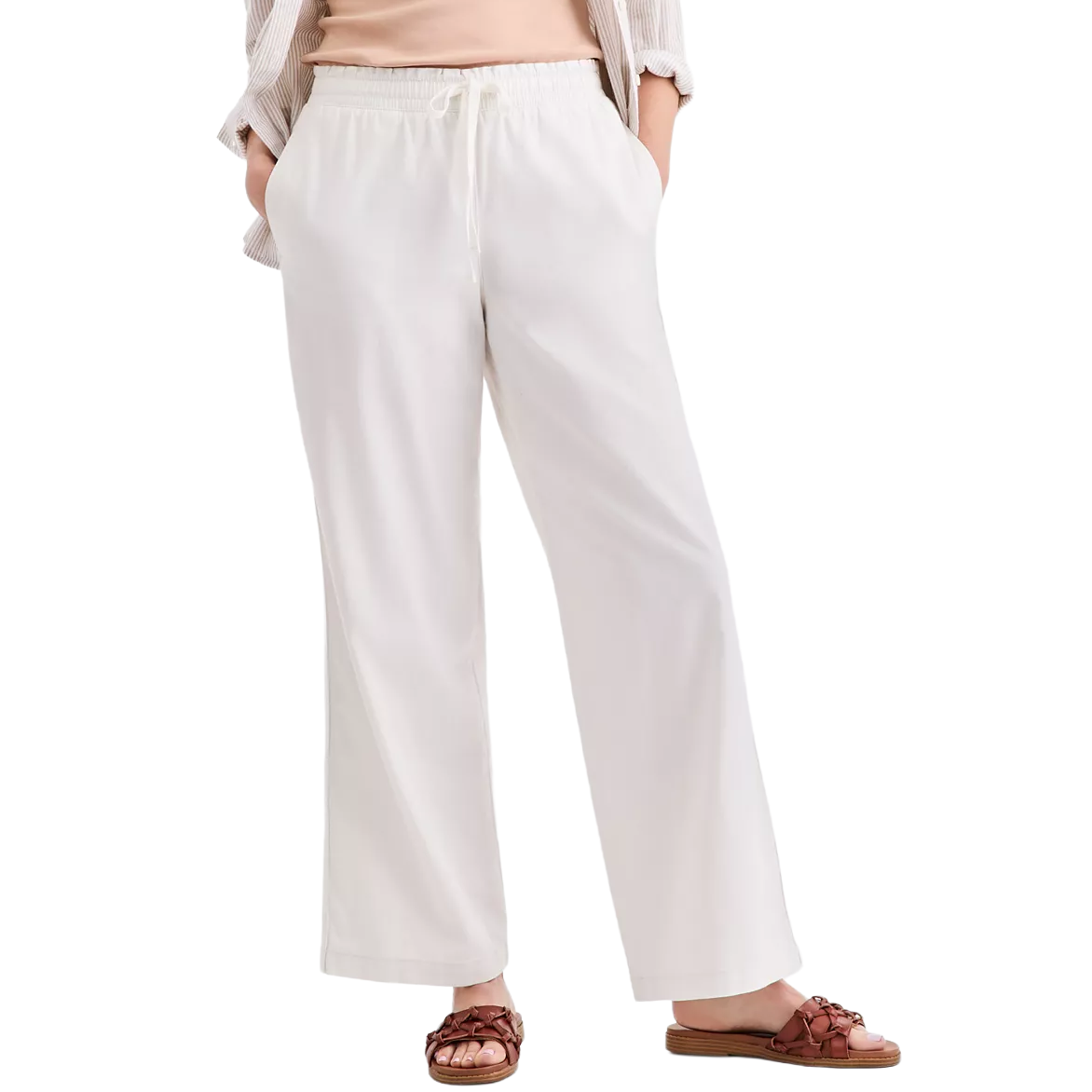 White wide-leg pants with an elastic waistband and drawstring, paired with brown flat sandals.