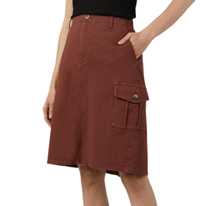 A rust-colored knee-length skirt with a front button and zip closure. Features pockets on both sides, including a buttoned cargo pocket on the right.