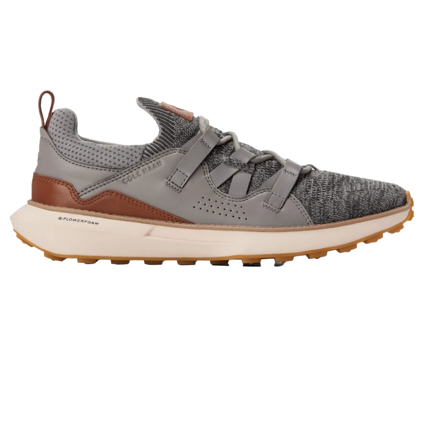 Cole Haan GrandMotion II Sneakers feature a gray and brown design with a breathable mesh upper, leather overlays, and a cushioned sole labeled \“Flowerfoam\“ for comfort.