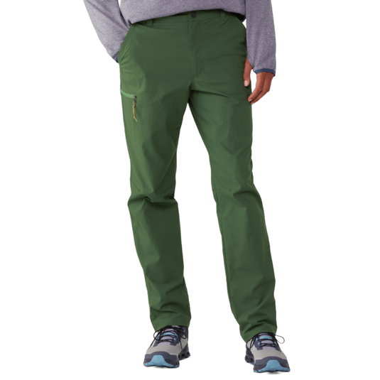 Green hiking pants with a zip pocket on the left thigh, paired with gray and blue trail shoes.