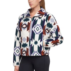 A woman is wearing a fleece jacket with a geometric pattern in white, purple, green, and brown, paired with black leggings.