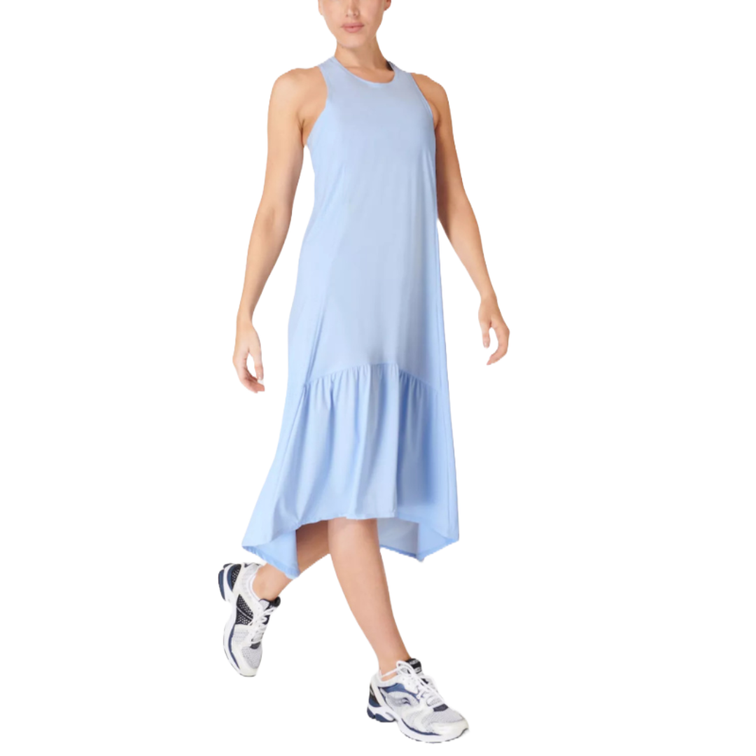 Light blue sleeveless midi dress with a racerback design and a high-low hem featuring a drop ruffle. Paired with white and navy athletic sneakers for a casual look.
