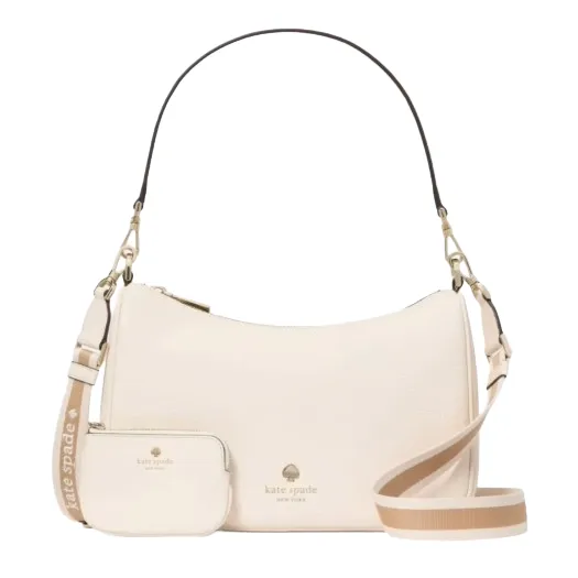 A cream Kate Spade shoulder bag with detachable strap and small matching pouch, featuring the brand's logo in gold.