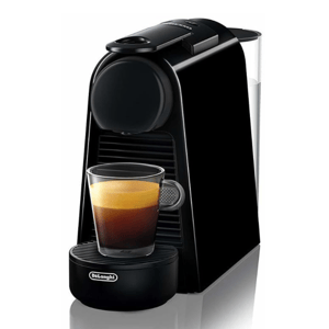 A compact Nespresso Essenza Mini coffee machine by De'Longhi, featuring a sleek black design with a small glass of espresso on the drip tray.