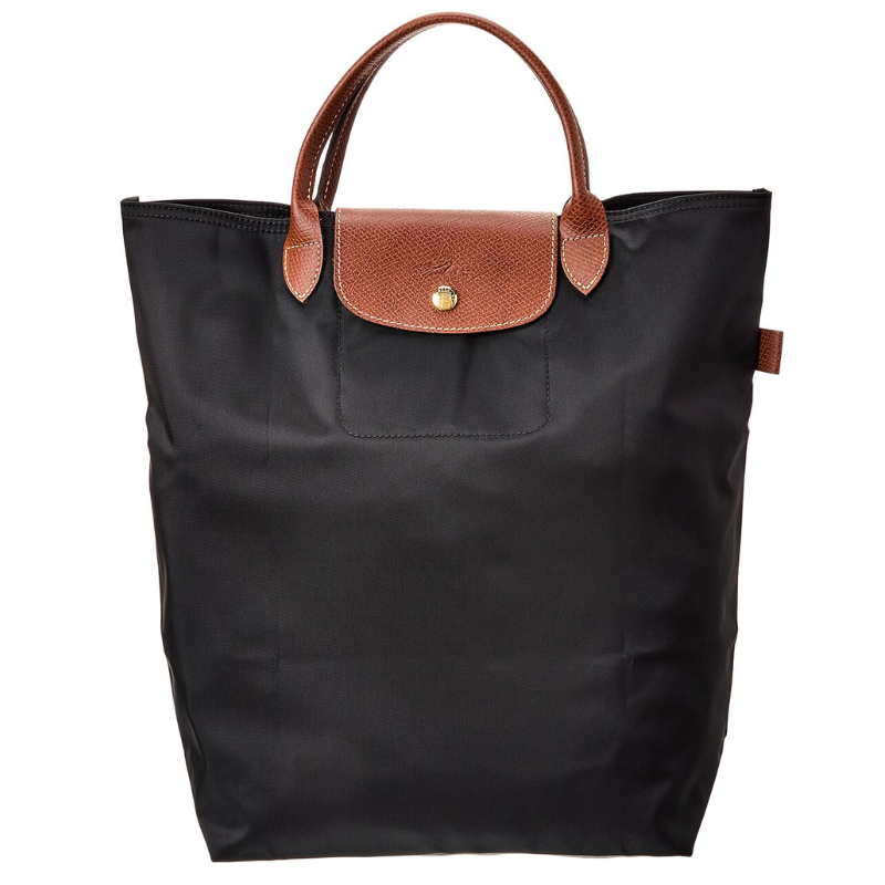 A black nylon tote bag with brown leather handles and flap closure, featuring a button detail.
