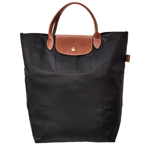 A black nylon tote bag with brown leather handles and flap closure, featuring a button detail.
