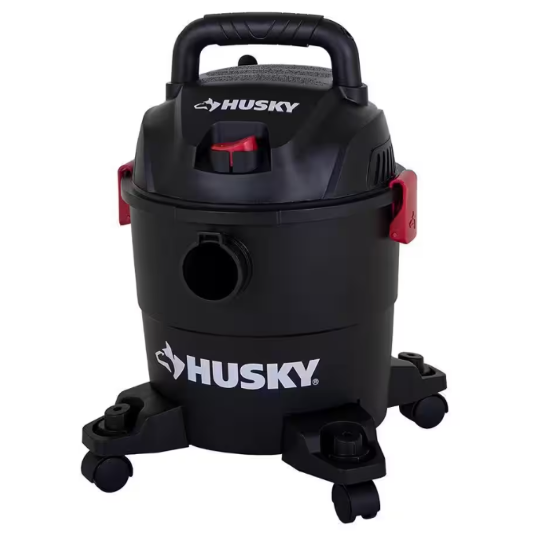 A black Husky brand wet/dry vacuum cleaner with red accents and caster wheels.