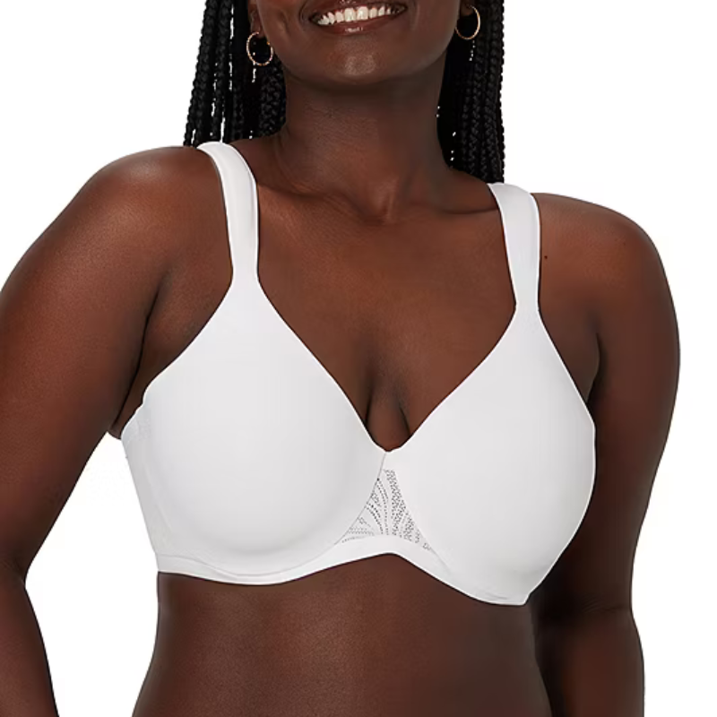 A woman is wearing a white full-coverage bra with wide straps and subtle lace detailing.