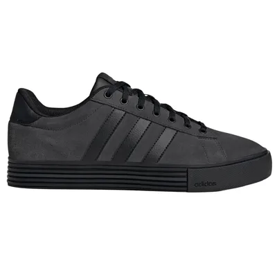 A black sneaker with a minimalist design, featuring subtle textured stripes and a sleek rubber sole. The shoe has a lace-up closure and a discreet brand logo on the side.