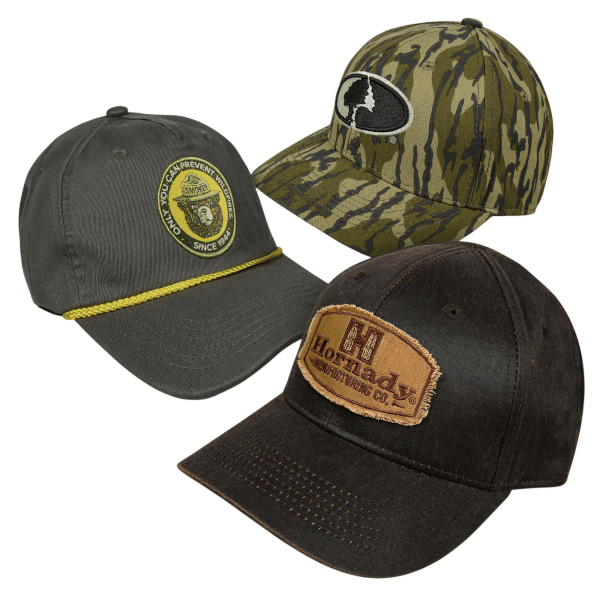 Three caps are shown: one dark with a \“Smokey Bear\“ patch and yellow cord, a camo hat with a tree logo, and a brown cap with a \“Hornady\“ patch.