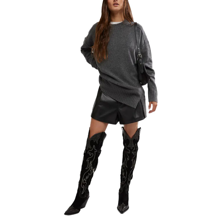 The Free People Phoebe Sweater is a cozy, oversized knit in dark gray with a relaxed fit and long sleeves, featuring ribbed detailing at the cuffs and hem.