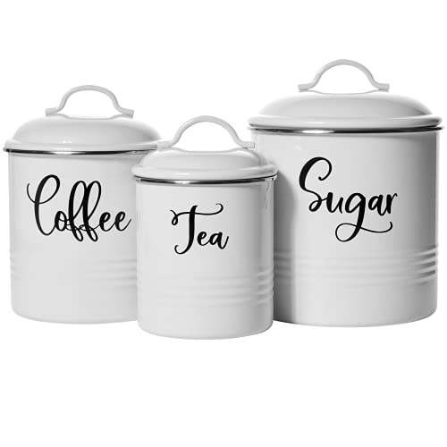 Three white steel containers with black cursive lettering labeled \“Coffee,\“ \“Tea,\“ and \“Sugar,\“ each with a matching lid and handle.