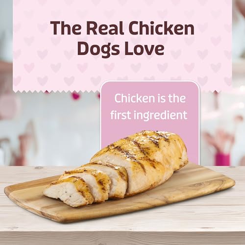 Grilled chicken breast on a wooden board with text highlighting \“The Real Chicken Dogs Love\“ and \“Chicken is the first ingredient\“.