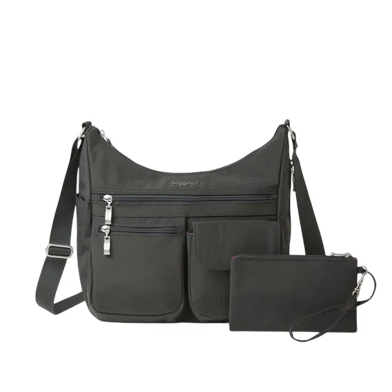 A dark grey crossbody bag with multiple exterior pockets, a zipper pouch, and an adjustable strap. Includes attached wristlet.