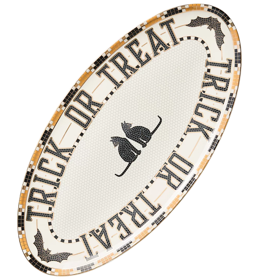Oval platter featuring a \“Trick or Treat\“ design with black cats and bats, styled in a mosaic pattern on a neutral background.