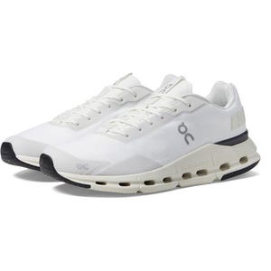 White running shoes with black soles and distinct circular cushioning elements.