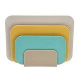 A set of four cutting boards in varying sizes and colors, including beige, yellow, and teal, designed for versatile kitchen use.